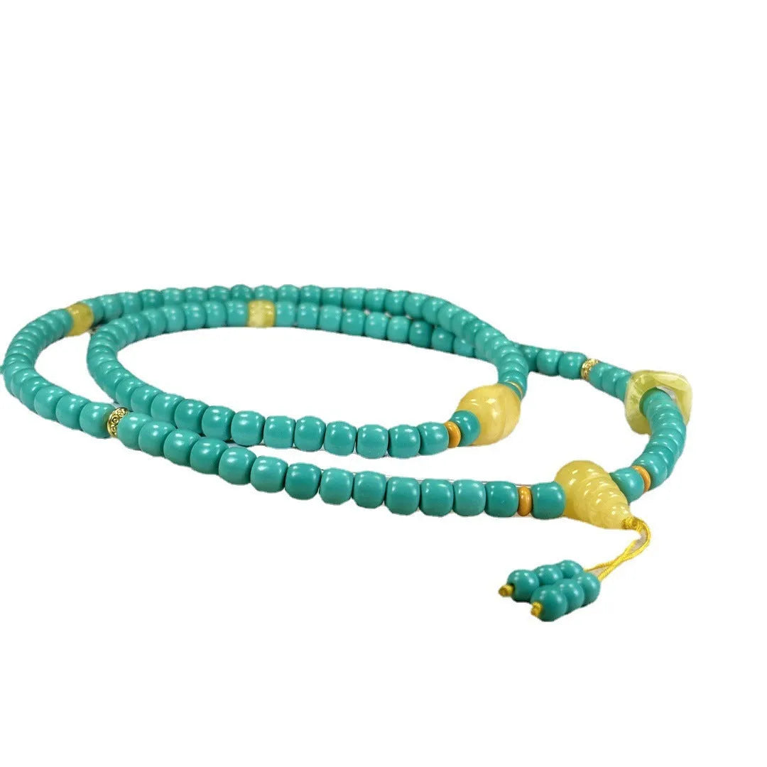 Turquoise lucky pendant necklace with hand-woven mesh flower design on adjustable ball bead chain