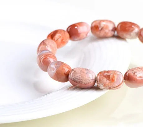 Agate barrel bead bracelet with cherry blossom colour and a ruyi element
