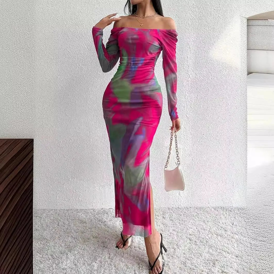 A woman wearing a long green mesh fishtail dress with pleats, a square collar, and a gradient colour print.