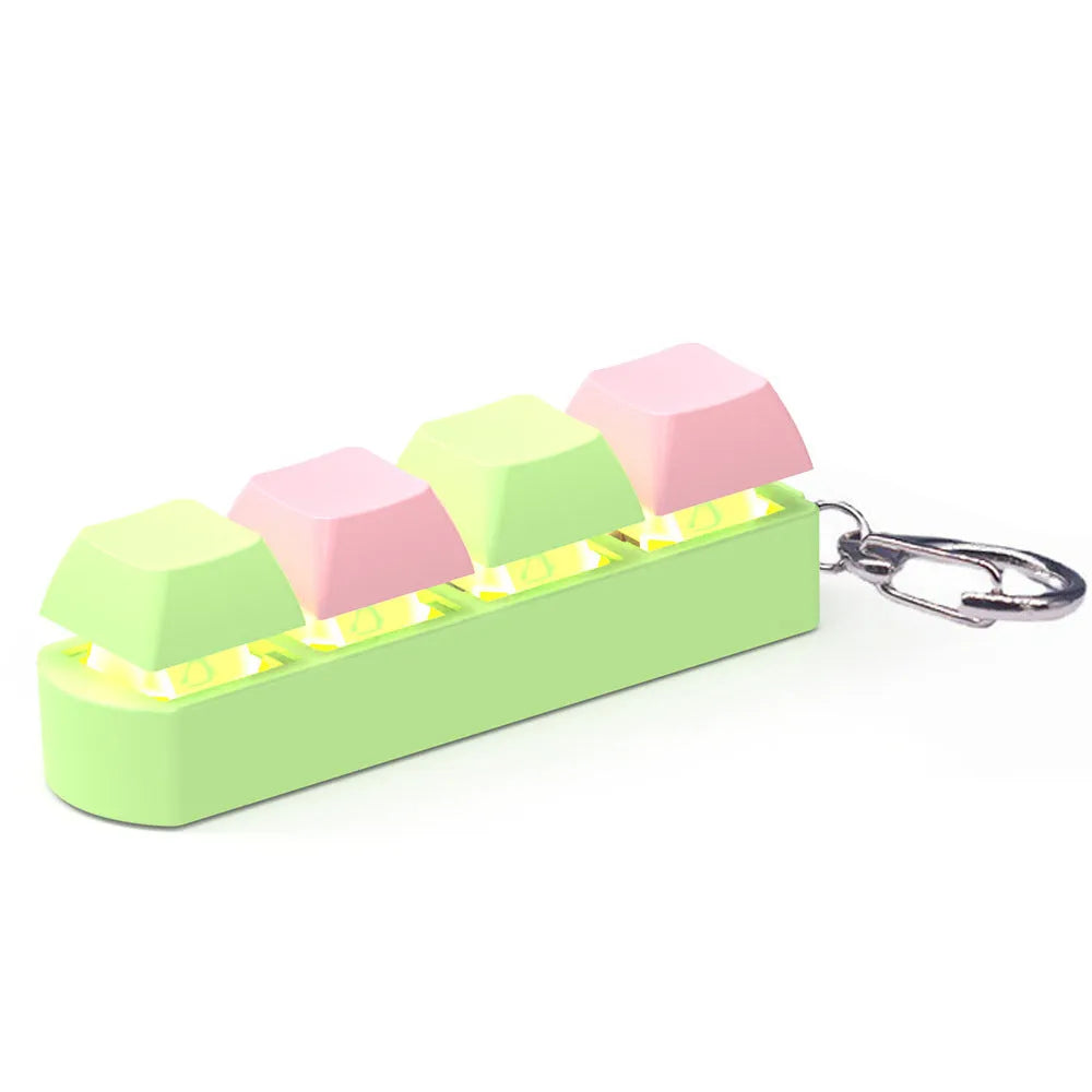 Compact 4-key mechanical keyboard switch tester on a desk, showing coloured ABS plastic construction.