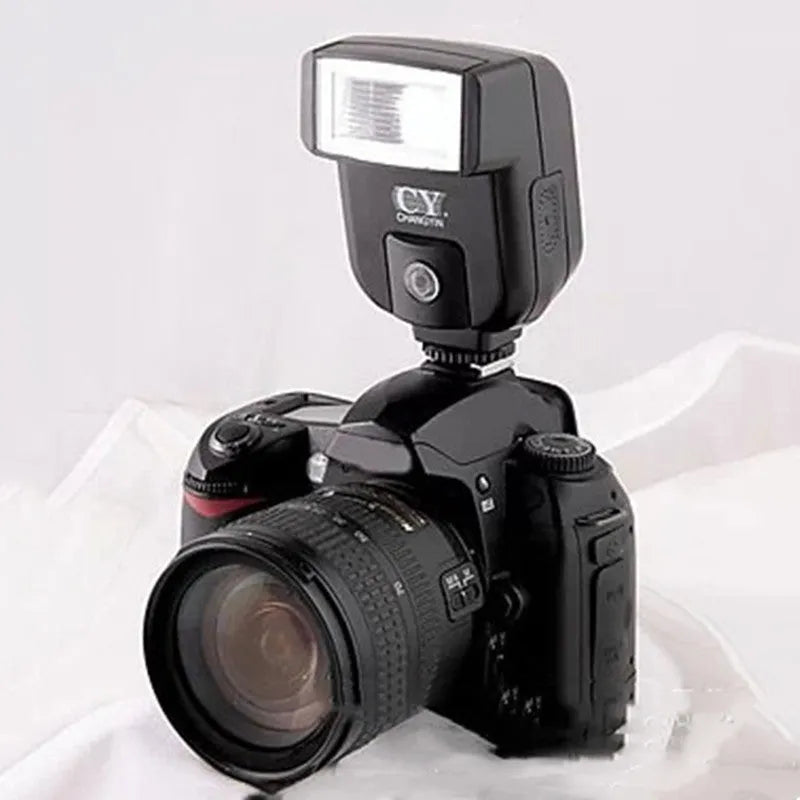 Silver hot shoe flash unit with head rotated upward, shown mounted on a DSLR camera.