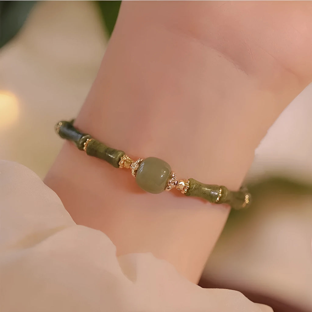 Hetian jade bracelet with geometric shape and round elements on female wrist