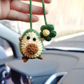 Handmade crocheted car pendant in avocado, pink rainbow, and red rainbow cartoon designs.