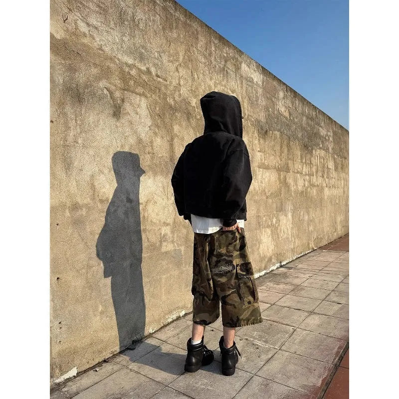 Men's loose fit camouflage patch ripped cropped jeans in a straight leg style.
