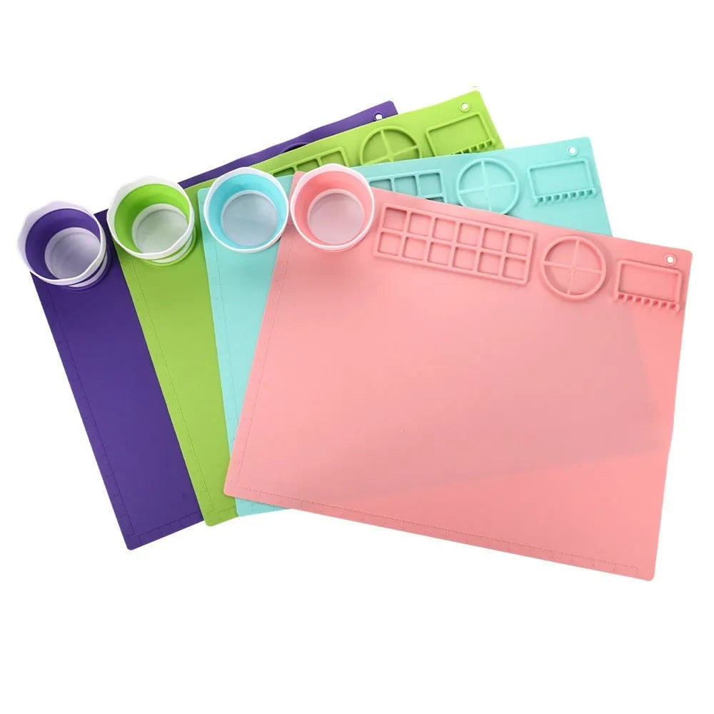 Light blue silicone painting mat with two attached bowls for watercolour supplies.