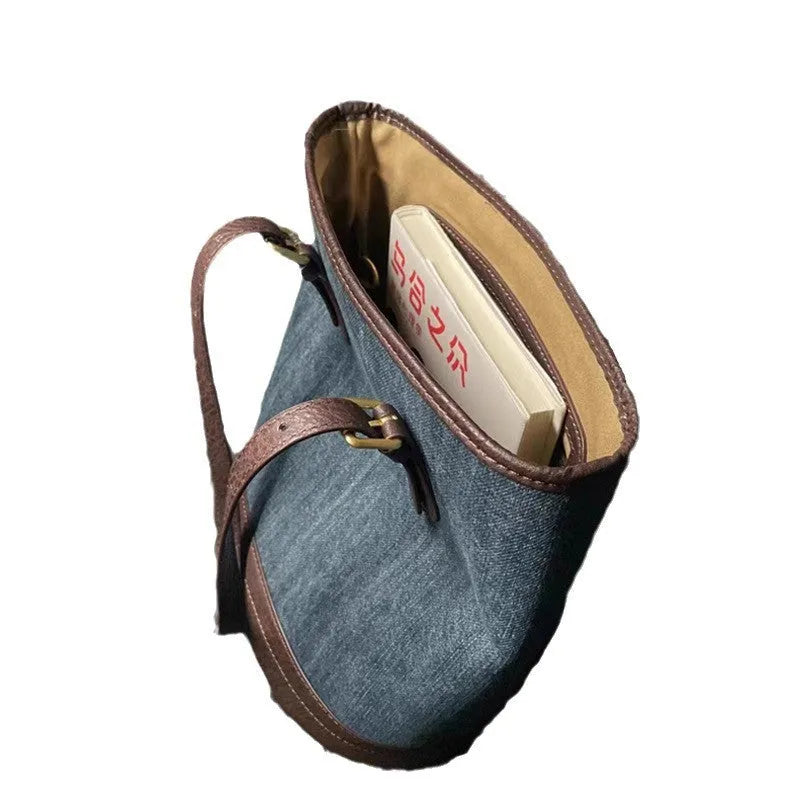 Denim patchwork handbag showing bucket shape with one-shoulder strap and patchwork detailing