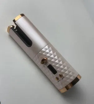 Portable white curling iron with a gold ceramic barrel, showing USB charging port and display with temperature settings.