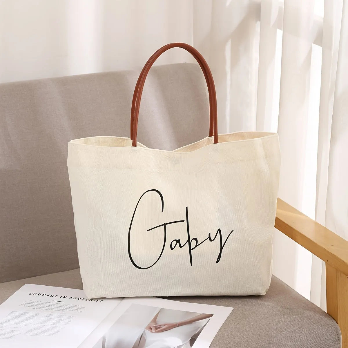 Beige white canvas tote bag with reinforced straps, shown flat and empty.