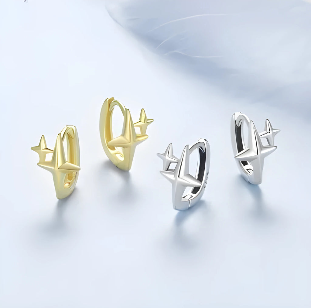 Minimalist star design silver ear clip with XINGX detail on a plain background.