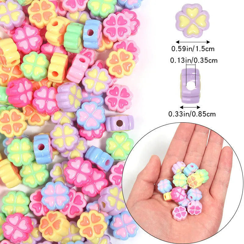 A selection of 15mm frosted acrylic beads in various colours, each showing a four-leaf clover love pattern.