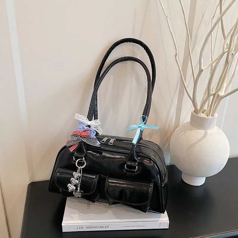 Retro-style black PU leather women's pillow bag with double shoulder straps and a flap closure.