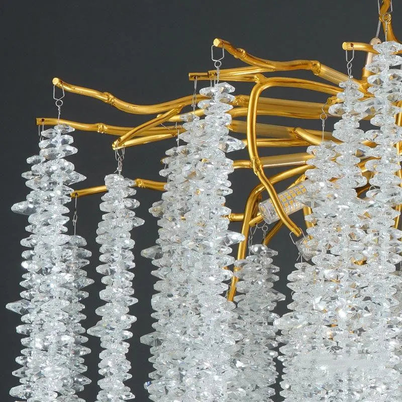 Modern crystal chandelier light with adjustable chain above a dining table.