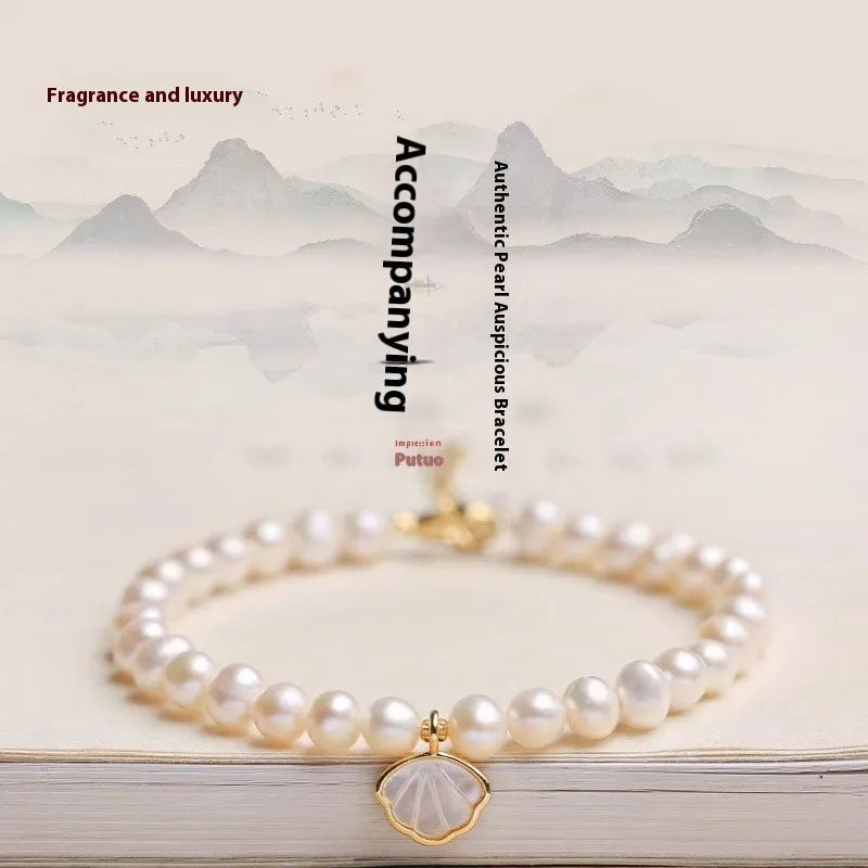 Women's freshwater pearl bracelet with fan-shaped alloy shell and choice of elastic or chain closure