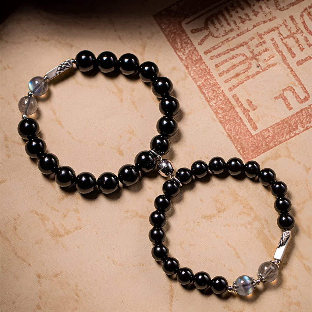Obsidian couple bracelet DIY kit with 8mm and 10mm black beads and cord for assembly.