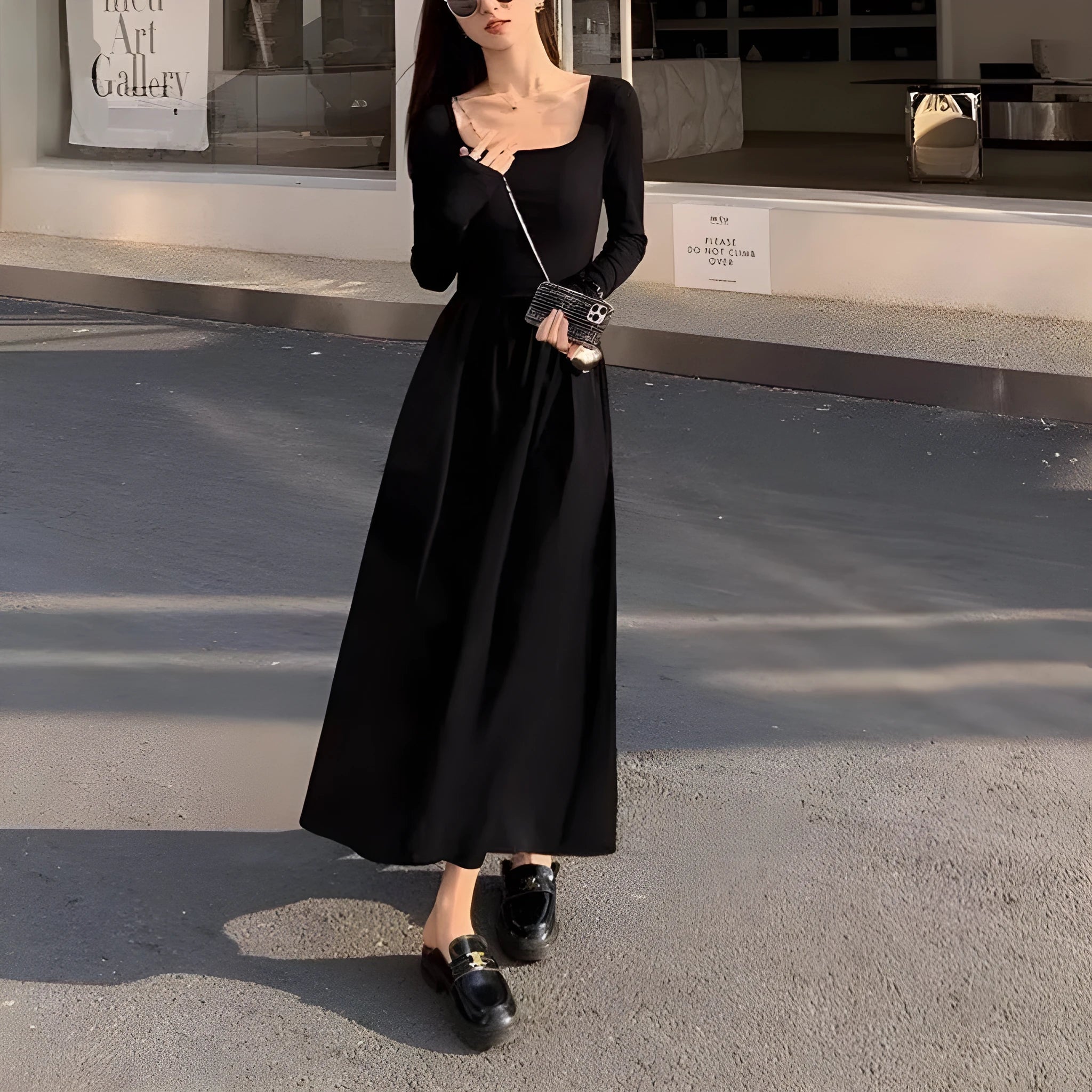 Women's black square collar A-line knitted dress with long sleeves and elastic waist.