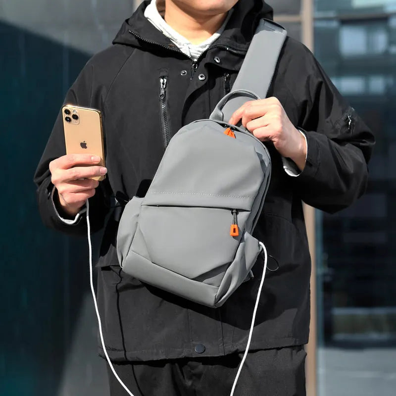 A black men's single shoulder crossbody bag made from polyester fabric.