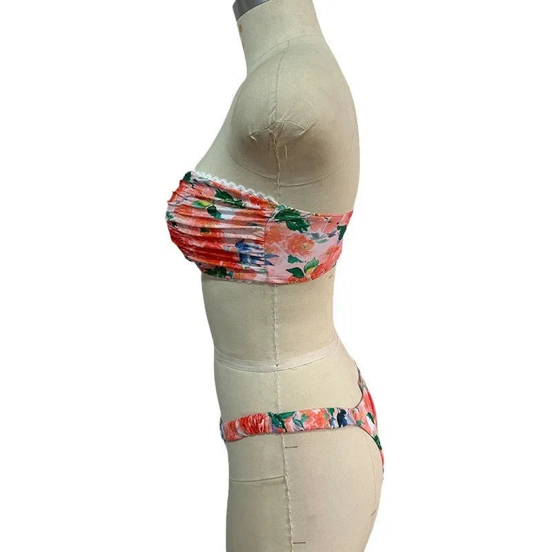 Women's floral print bikini set with lace trim on a tube top and briefs in blue.