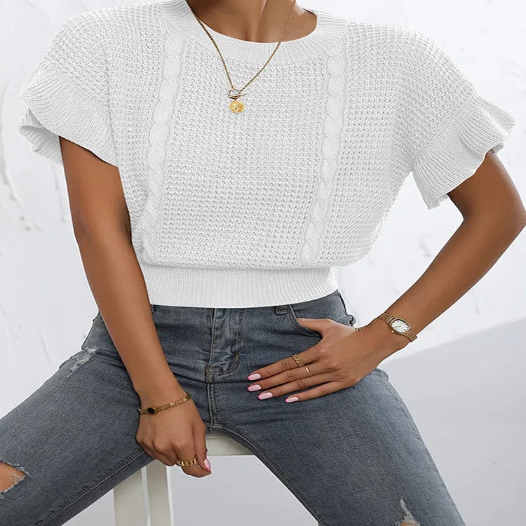 Knitted pullover sweater with ruffled short sleeves and a textured 3D pattern in a loose fit.