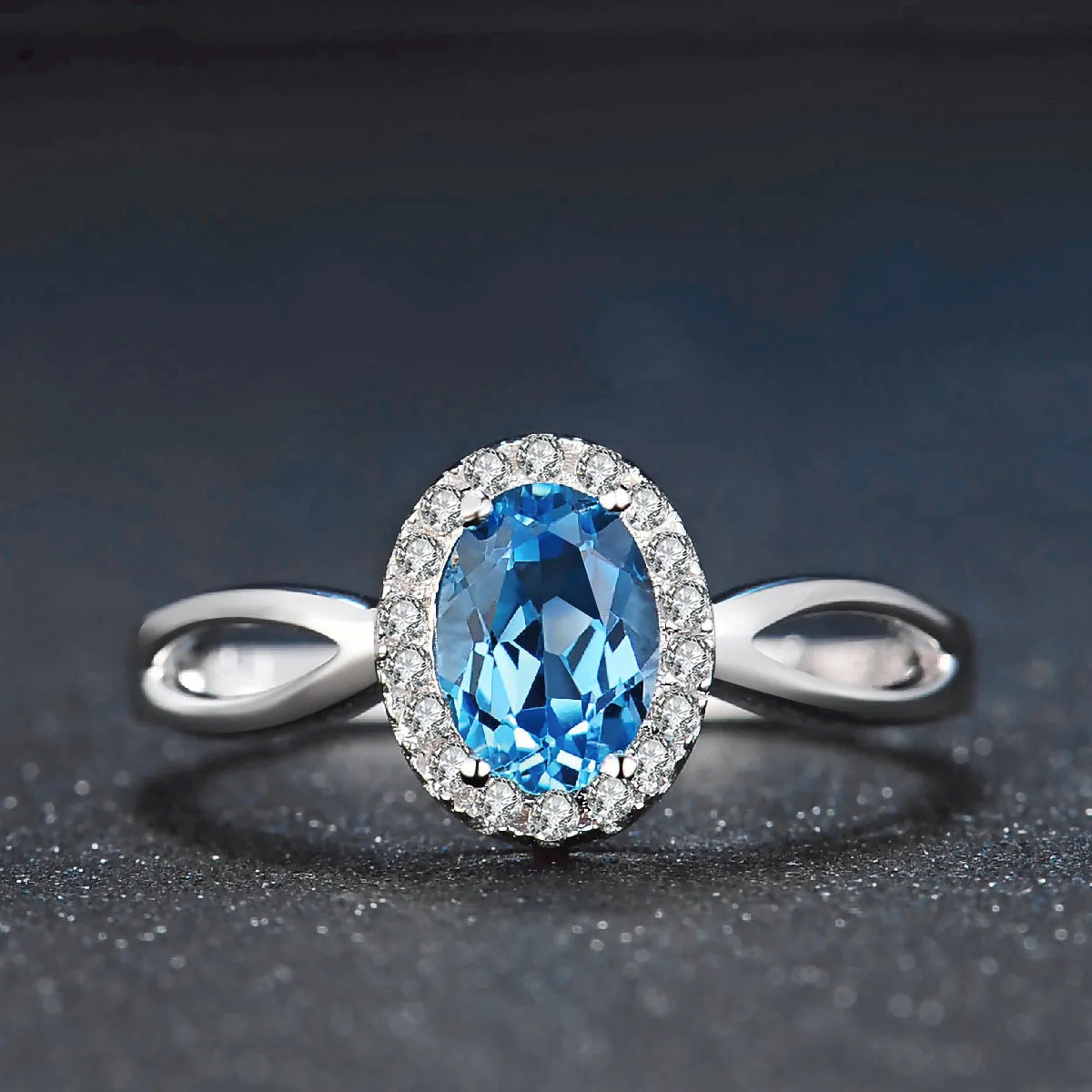 Four-piece sterling silver jewellery set with blue topaz stones including geometric earrings, ring, bracelet and necklace