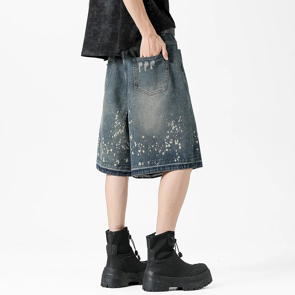Men's retro blue denim shorts with ripped detailing and splash ink patterns in straight cut design