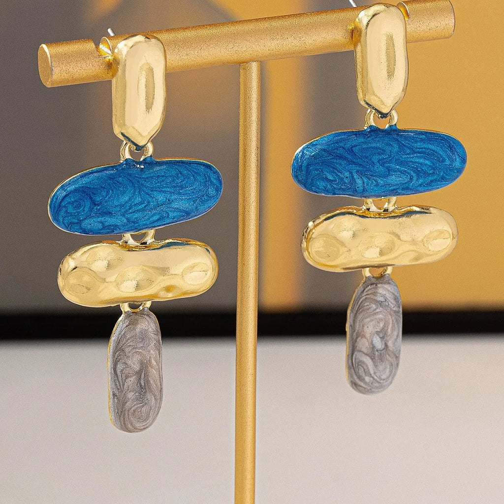 Gold-electroplated zinc alloy geometric stud earrings on a plain background.