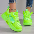 Women's purple platform mesh sneakers with lace-up front on wooden floor