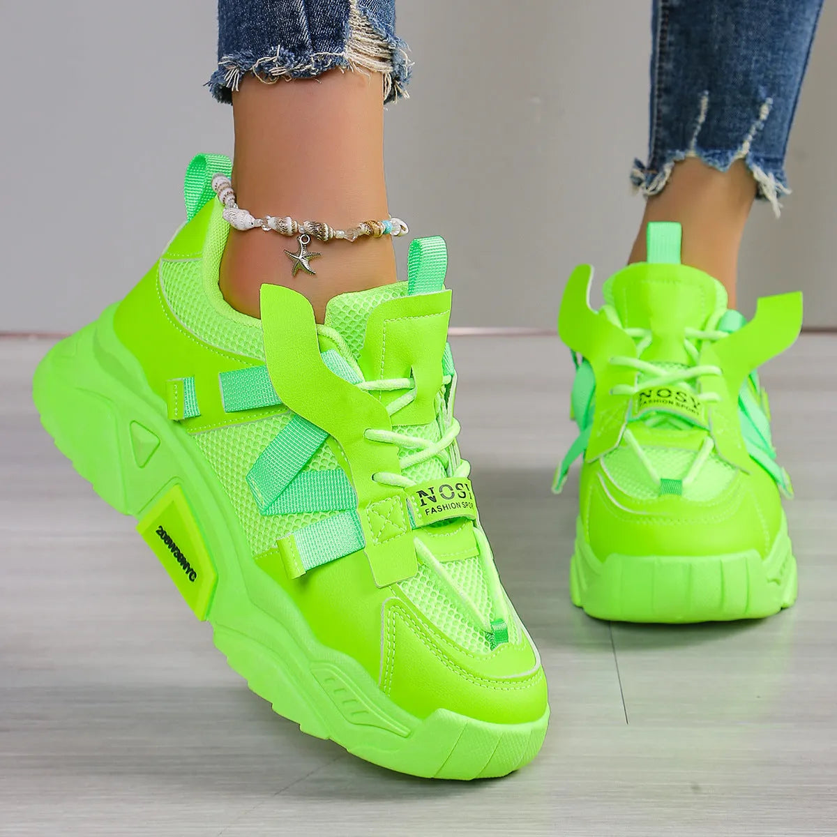 Women's purple platform mesh sneakers with lace-up front on wooden floor