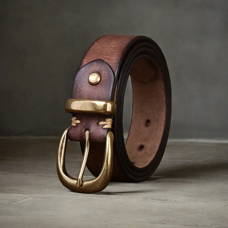 Men's brown genuine cowhide leather belt with a copper pin buckle on a jeans background.