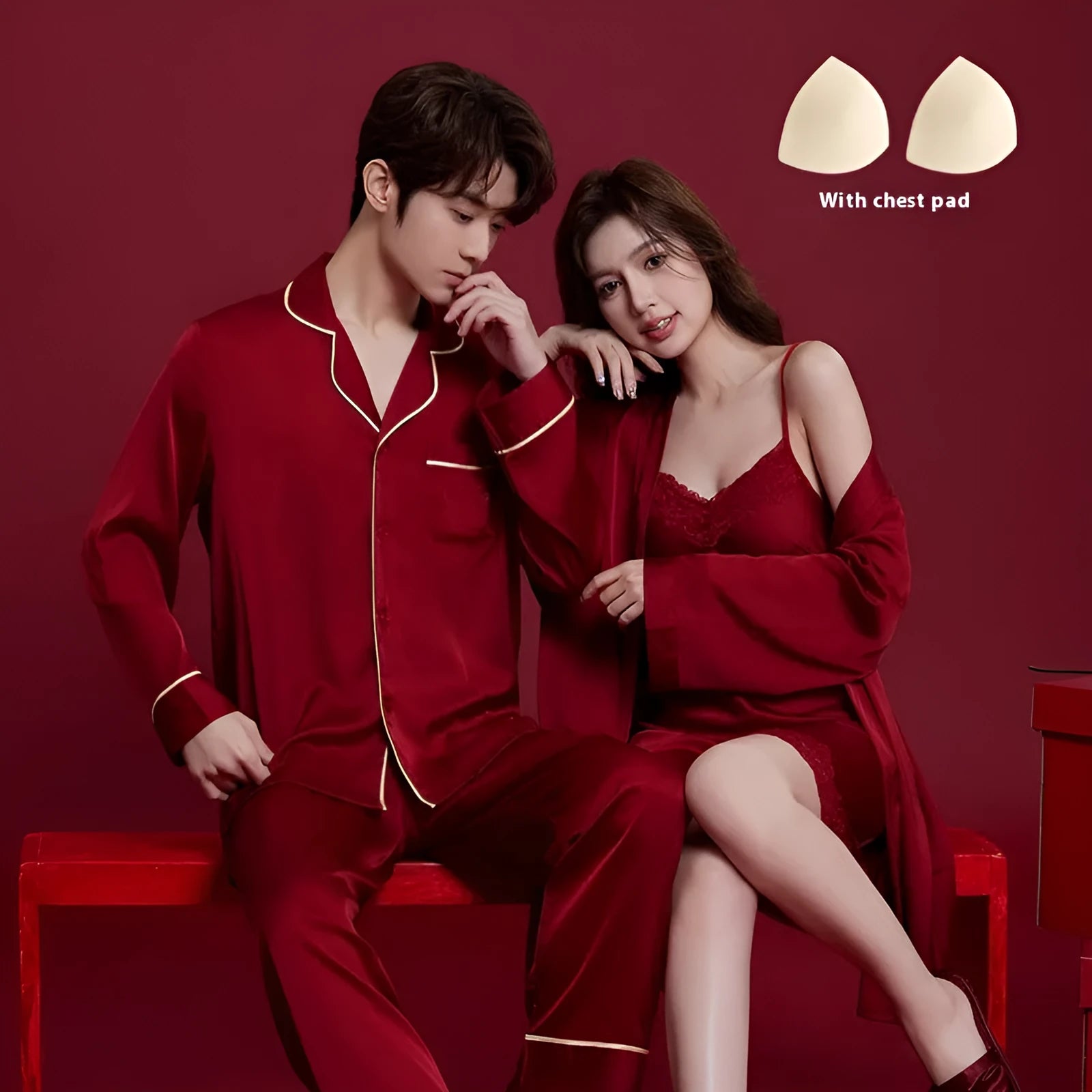Red long-sleeve ice silk sleepwear set for a man and woman on hangers.