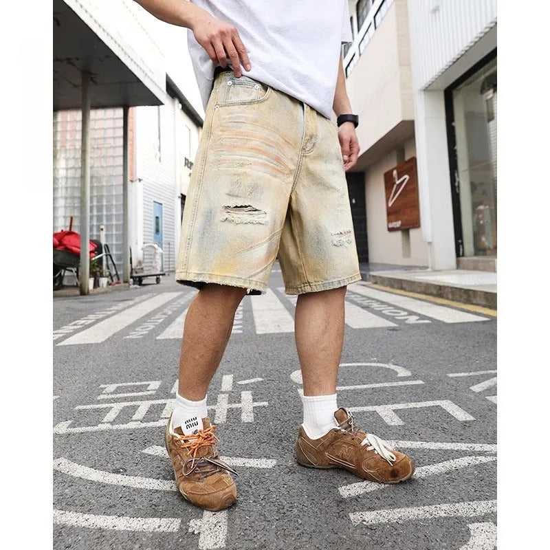 Light blue men's denim shorts with a washed finish and ripped detailing on a straight-leg cut.
