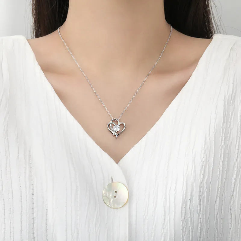 Close-up of a 925 silver heart-shaped pendant necklace on a chain.