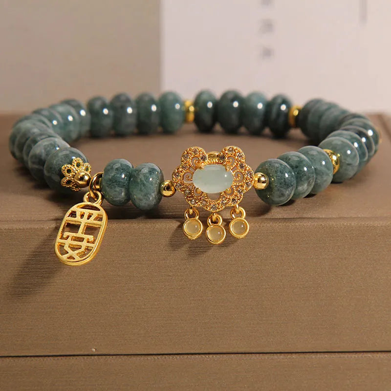 Women's natural emerald jade bracelet with alloy construction showing abacus bead design and safety lock closure