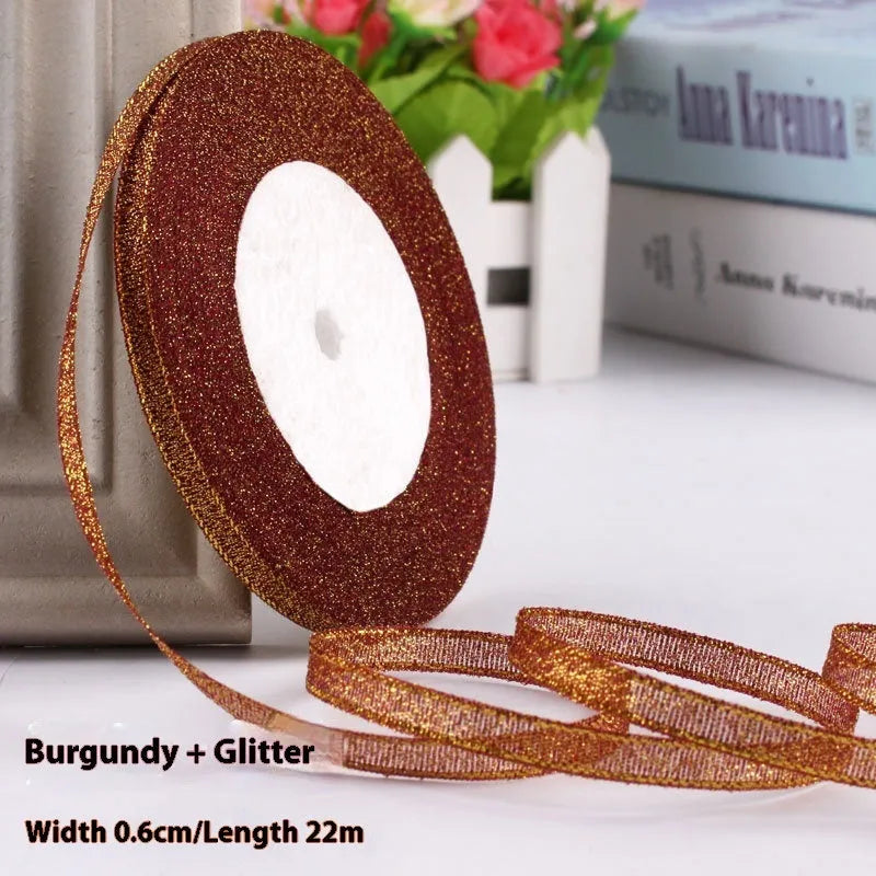 Roll of 0.6cm wide polyester gift ribbon in multiple colour options including gold leaf and red onion.