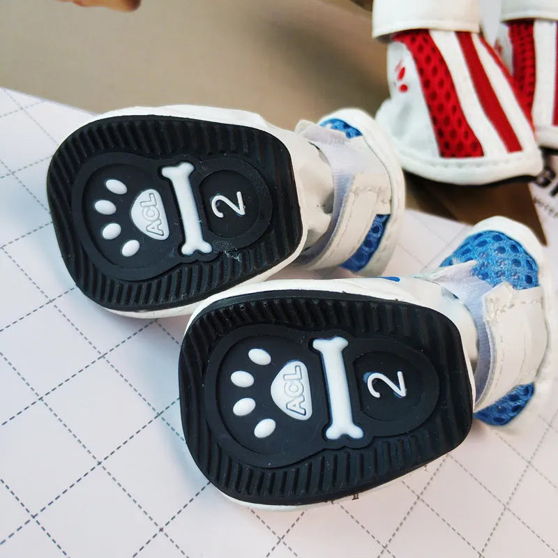 Set of four blue cloth dog shoes with zip closures and non-slip soles for small dogs.