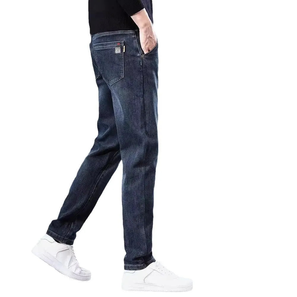 Man wearing blue grey slim straight casual trousers with a loose fit and zip fly for summer street fashion