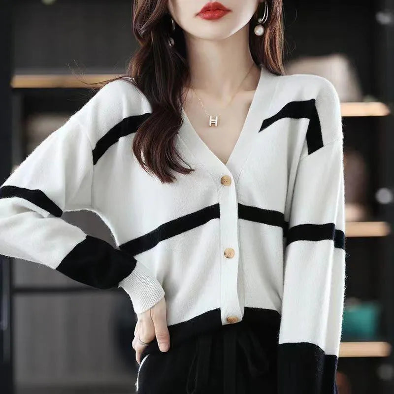 Women's striped V-neck knit cardigan buttoned up, shown in a slim fit.