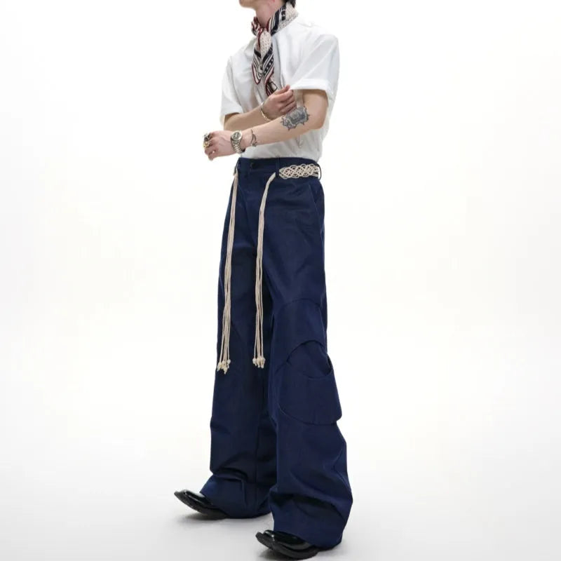 Men's dark blue straight-leg trousers with 3D cutting, zipper decorations, and a tassel pocket detail on a micro-elastic cotton fabric.