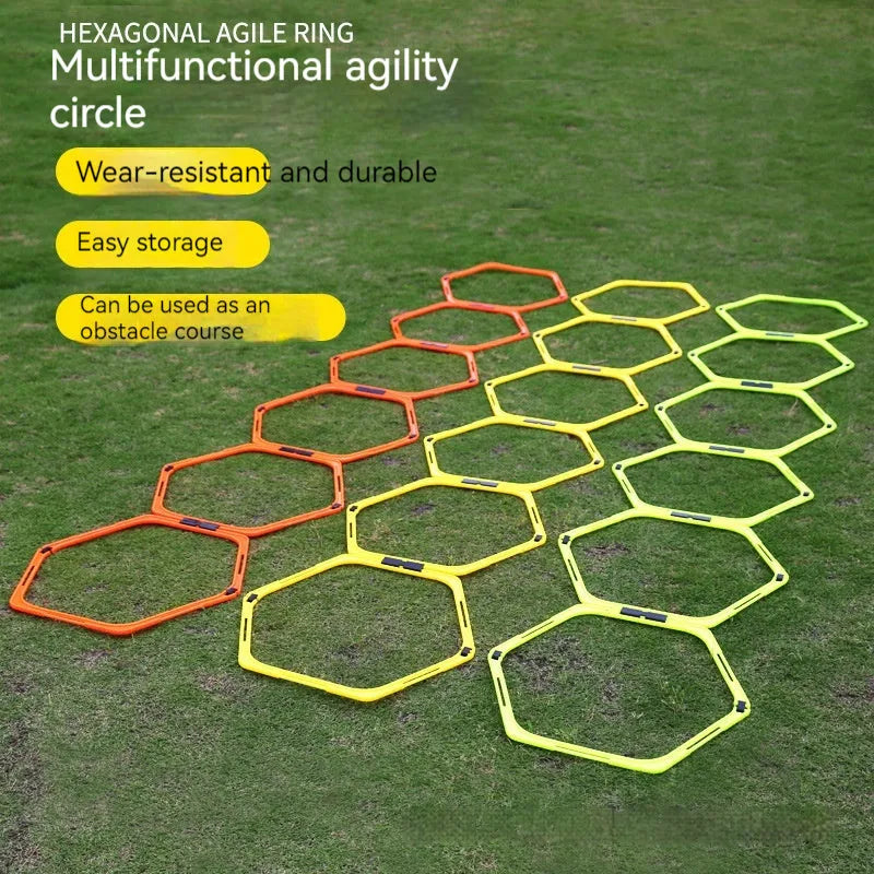 Six foldable hexagon agility training rings in green, orange, and yellow colours laid out on grass.