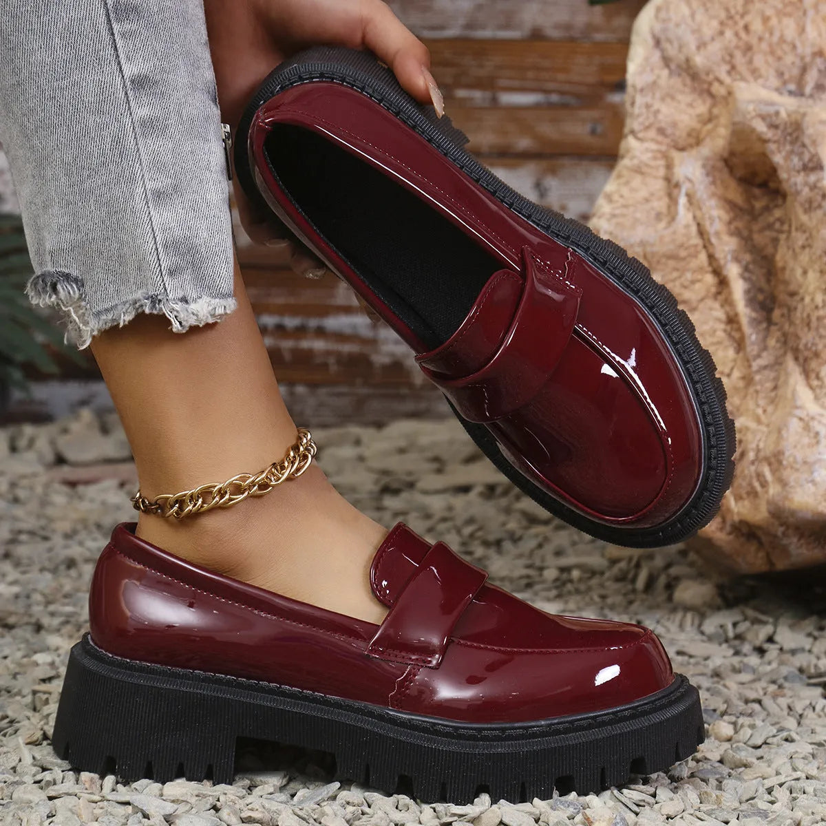 Women's plus size black slip-on loafers with a chunky mid-heel and rubber sole.