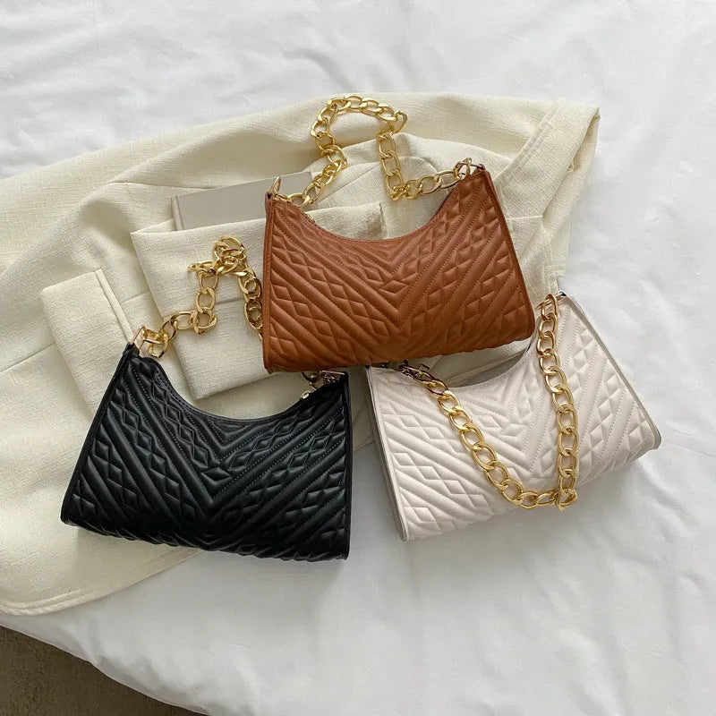 Brown pleated chain strap baguette shoulder bag with a vertical square shape and soft carry handle.