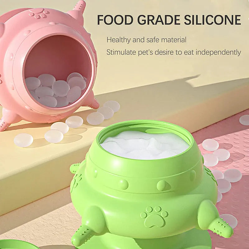 Pink silicone pet milk feeder with four nursing nipples for puppies and kittens on a flat base.