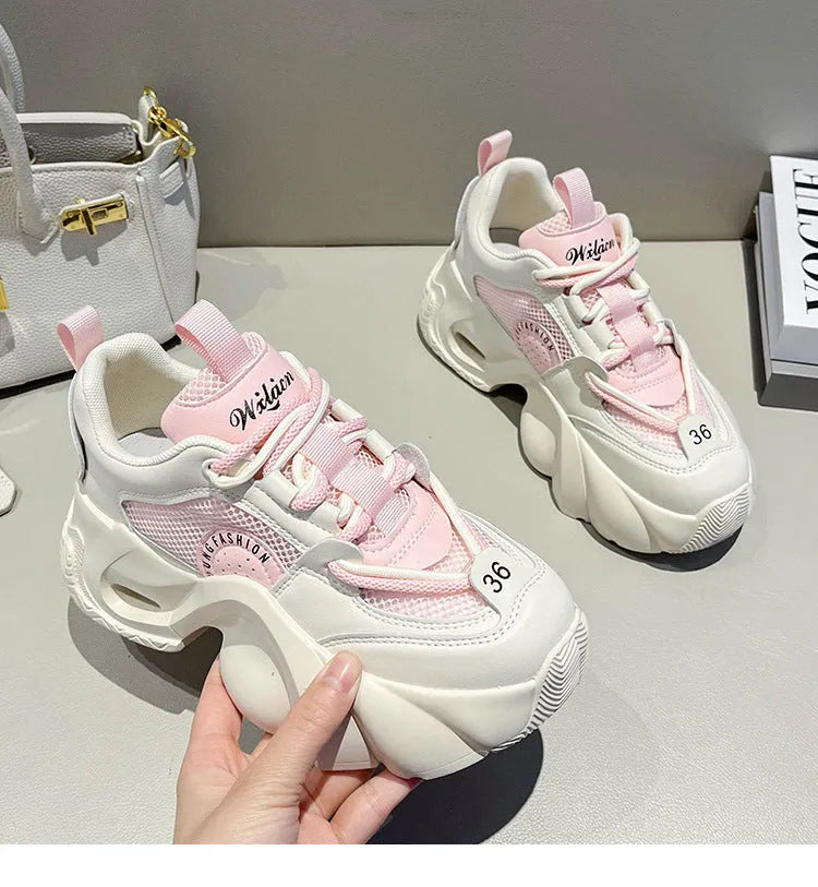 Women's pink casual sneakers with thick sole and cross-shoulder straps on a white background