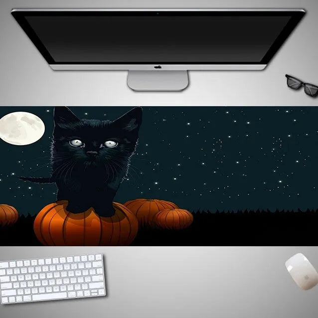 Oversized Halloween-themed mouse pad with non-slip rubber cloth base on a desk
