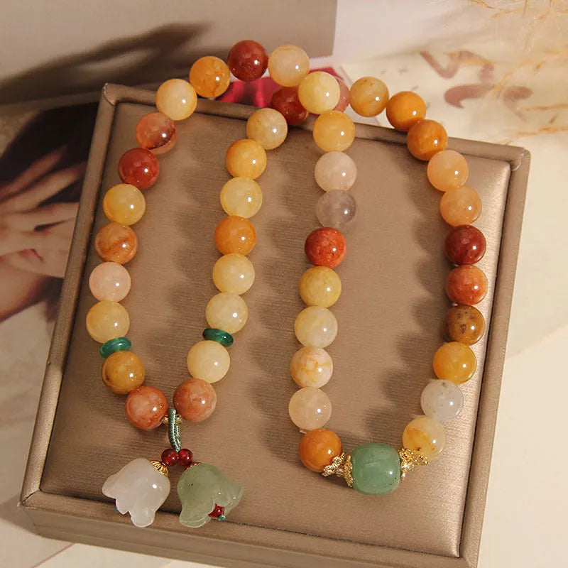 Natural jade multi-layer bracelet for women with a white orchid pendant charm on an elasticated cord