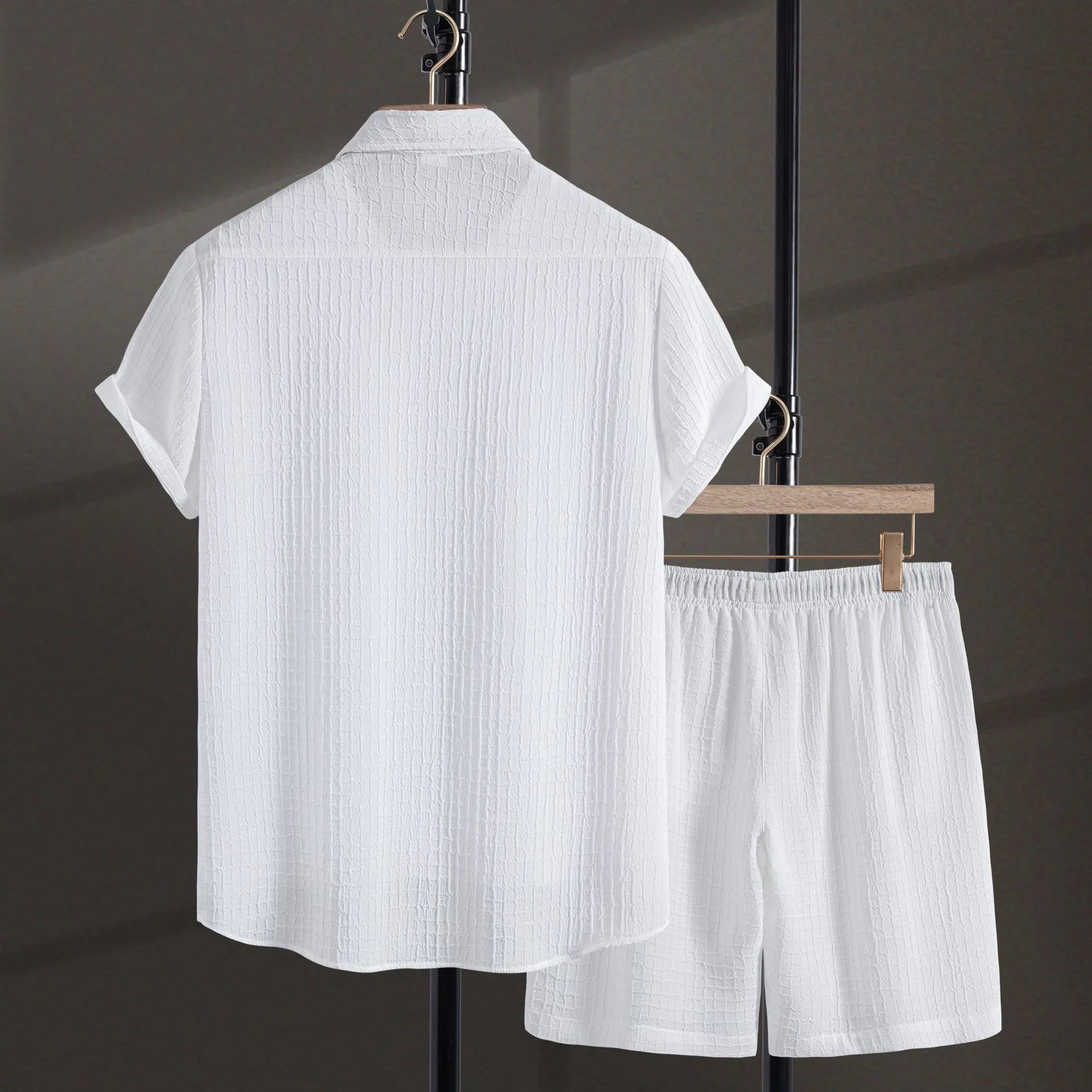 Men's black jacquard patterned short sleeve shirt and matching casual shorts laid flat.