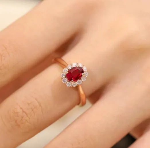Sterling silver ring with gold pigeon design, floral pattern and red blood gemstone accents