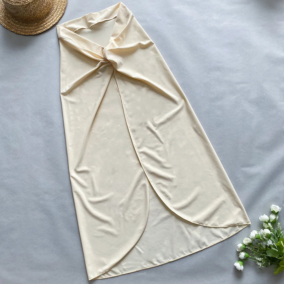 Women's brown one-piece swimsuit with matching beige skirt swimwear set on a neutral background.