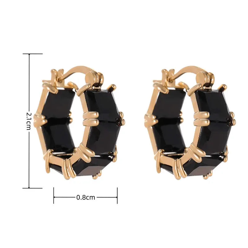 Geometric U-shaped gold tone earring with a round black zircon stone.