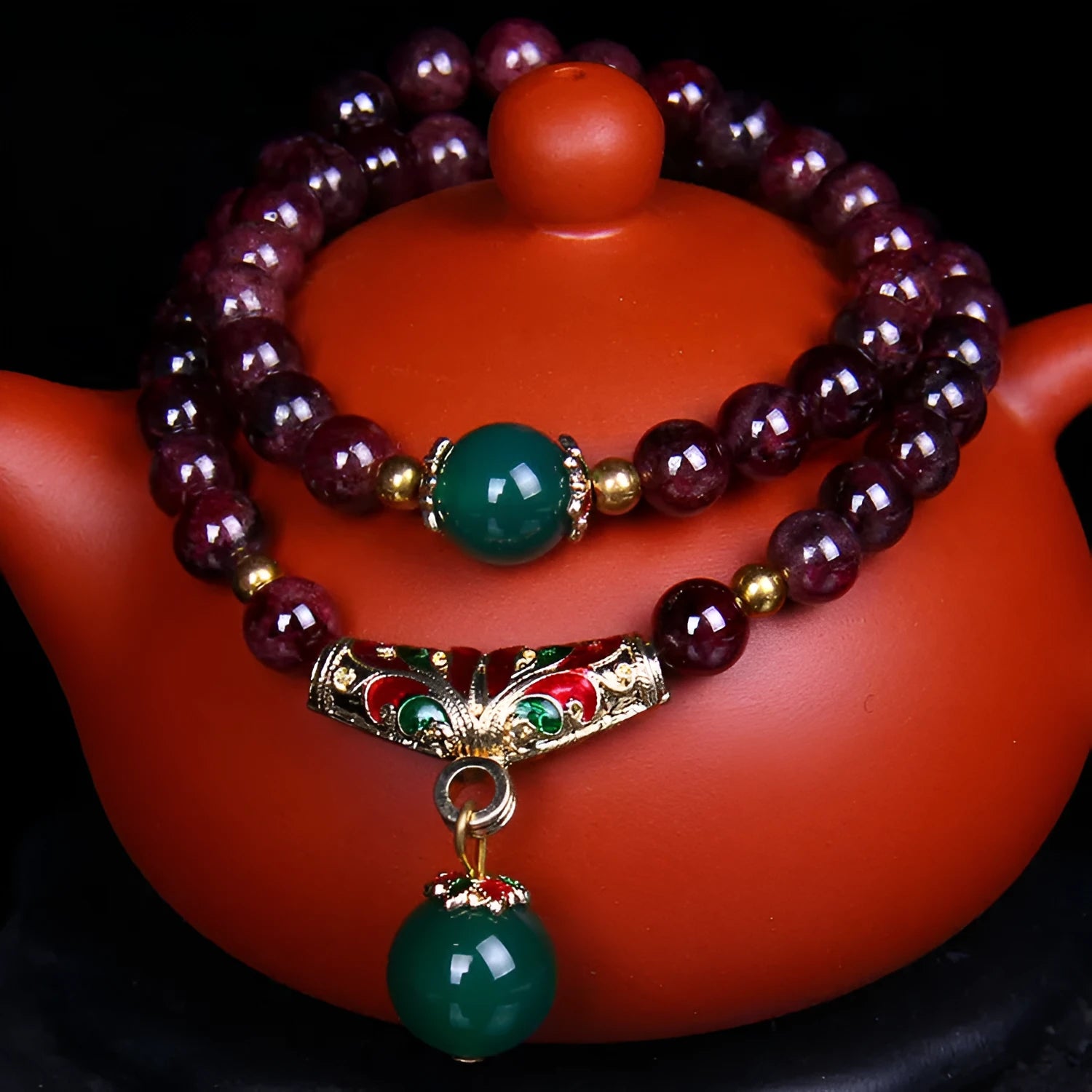 Women's natural garnet bracelet with 7mm beads, double ring closure and Golden Toad charm
