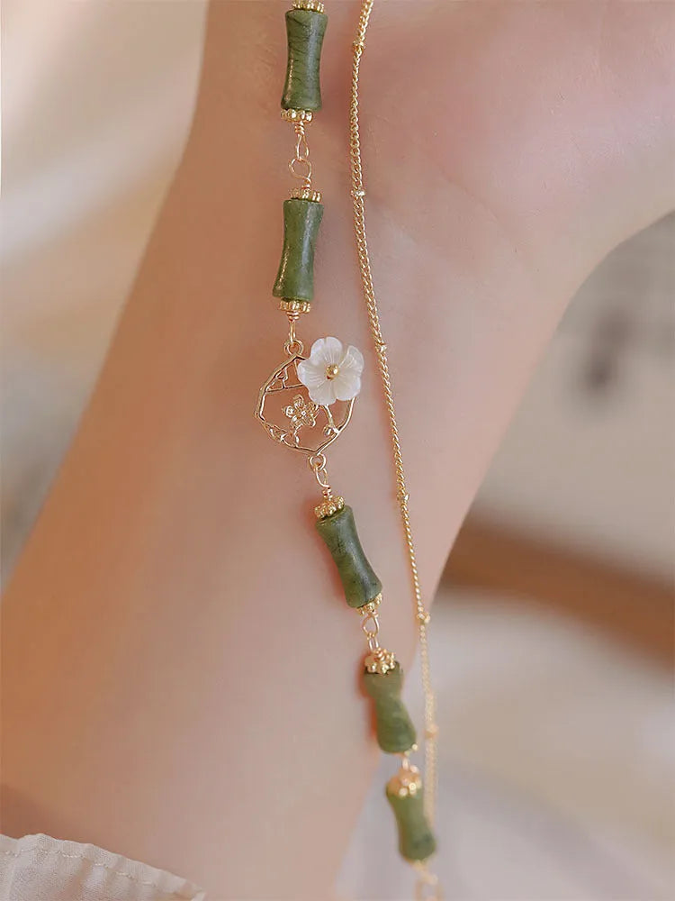 Handmade olivine bracelet with double layer design and twin charms on wrist